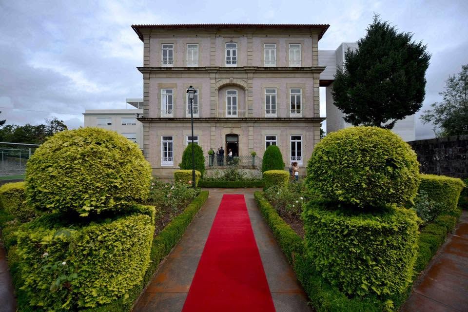 The Polo building seen from the garden, with clipped hedges and a red carpet leading to the entrance
